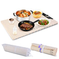 The mat laid with a pot, a pan and three bowls, its storage bag rolled up beside it