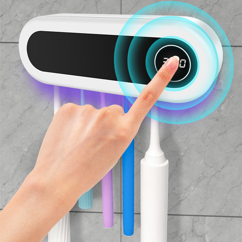 A finger pressing the button on the front, the display showing 360