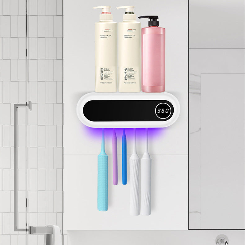 The holder on a tiled bathroom wall, above the basin