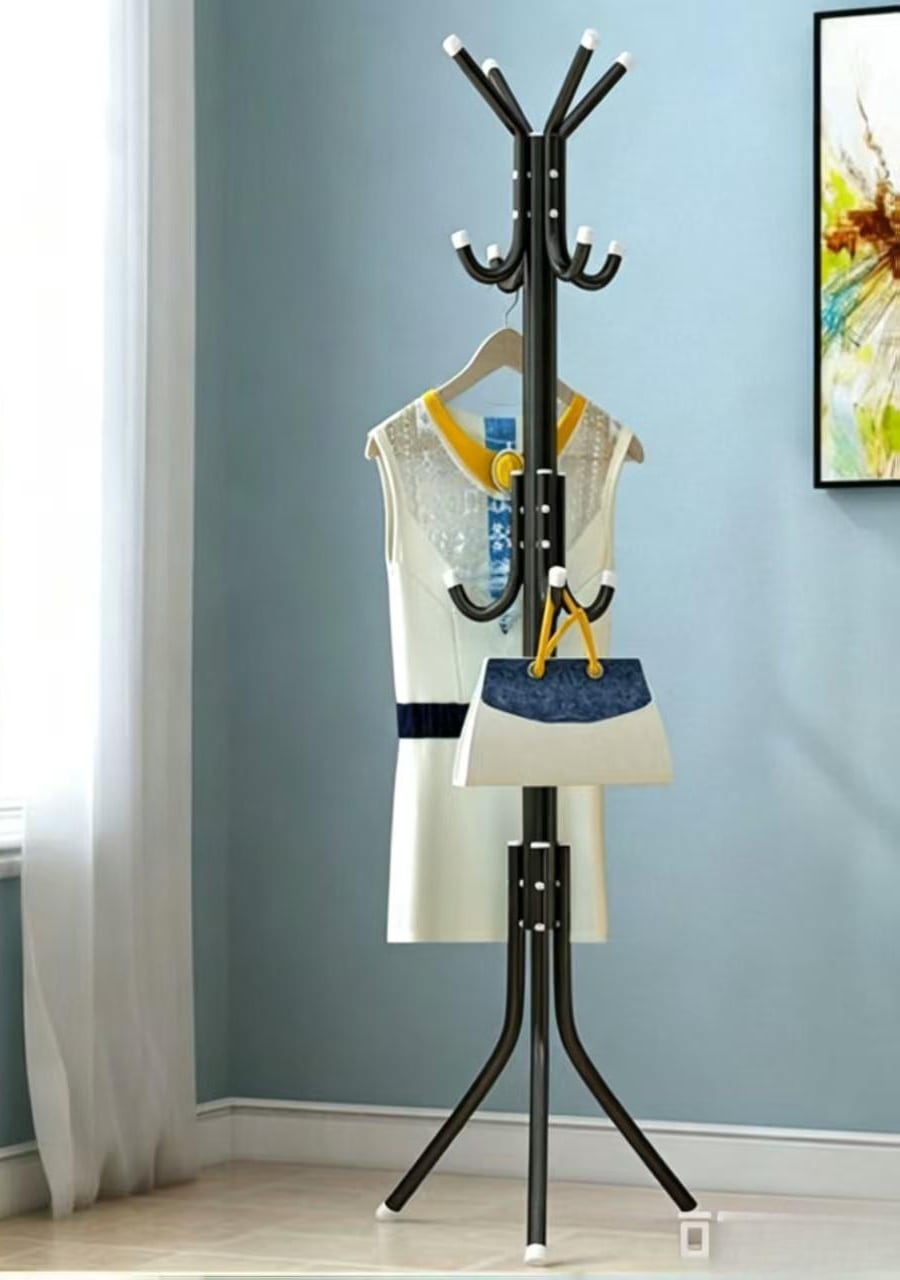 The rack in a corner of a room, a jacket and a bag hanging from it